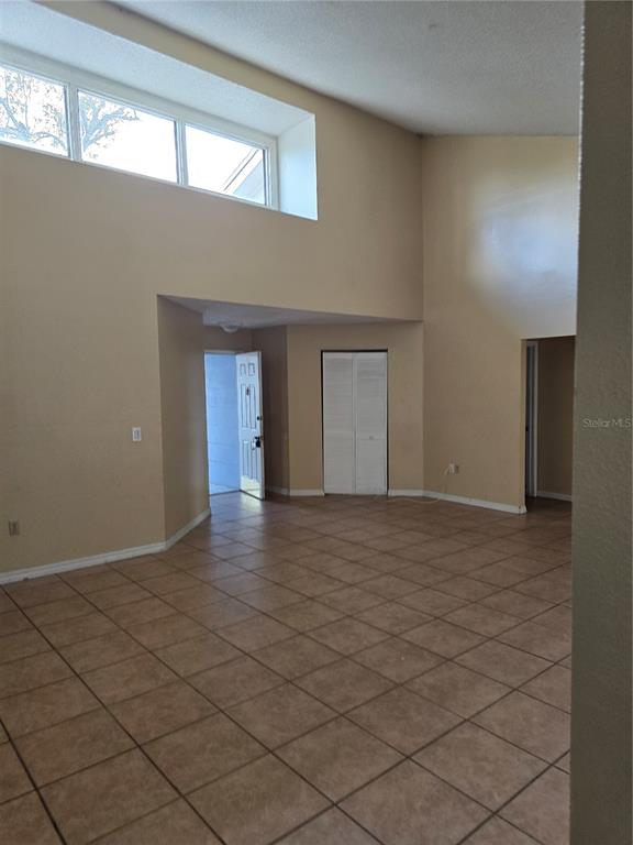 710 Stillview Circle Brandon, FL 33510 - Photo 4 of 5 a view of an empty room with window and chandelier fan