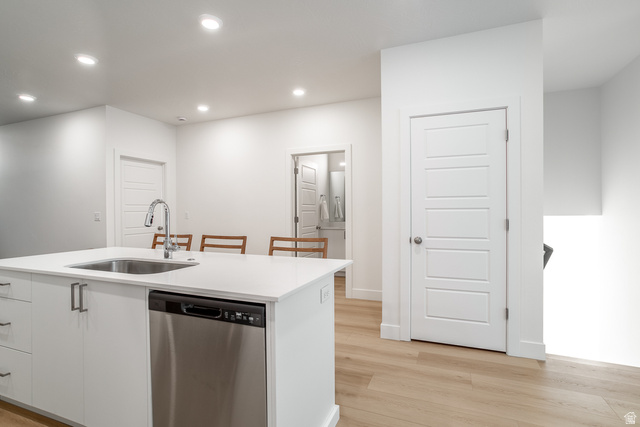 2768 Becco Trail, Unit 63 St. George, UT 84770 - Photo 5 of 27 Kitchen featuring stainless steel dishwasher, a kitchen island with sink, recessed lighting, light wood-style floors, and white cabinetry