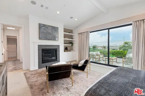 a living room with furniture potted plant and window