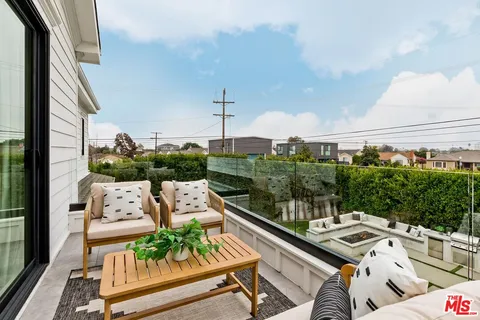 a living room with furniture a chandelier and a window