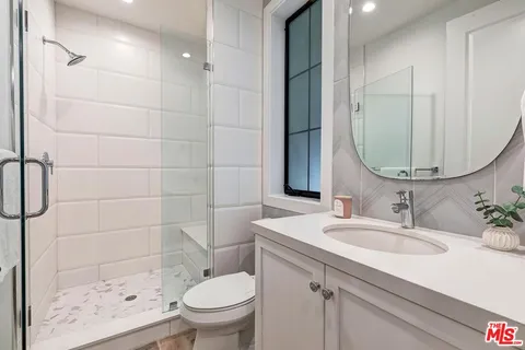 a living room with furniture a fireplace and a large window
