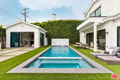 a living room with furniture and a fireplace with garden view