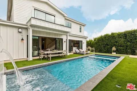 a view of yard with swimming pool and seating
