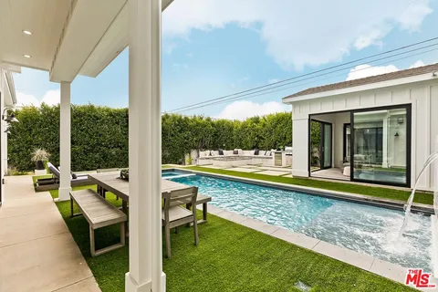 a view of a house with a backyard and a patio