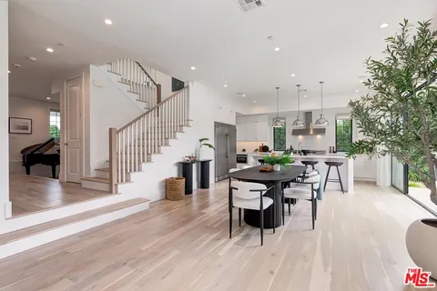 a living room with furniture a large window and a fireplace