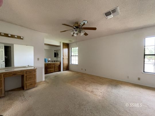 833 West Perdew Avenue Ridgecrest, CA 93555 - Photo 6 of 8 a view of a big room with chandelier fan and windows
