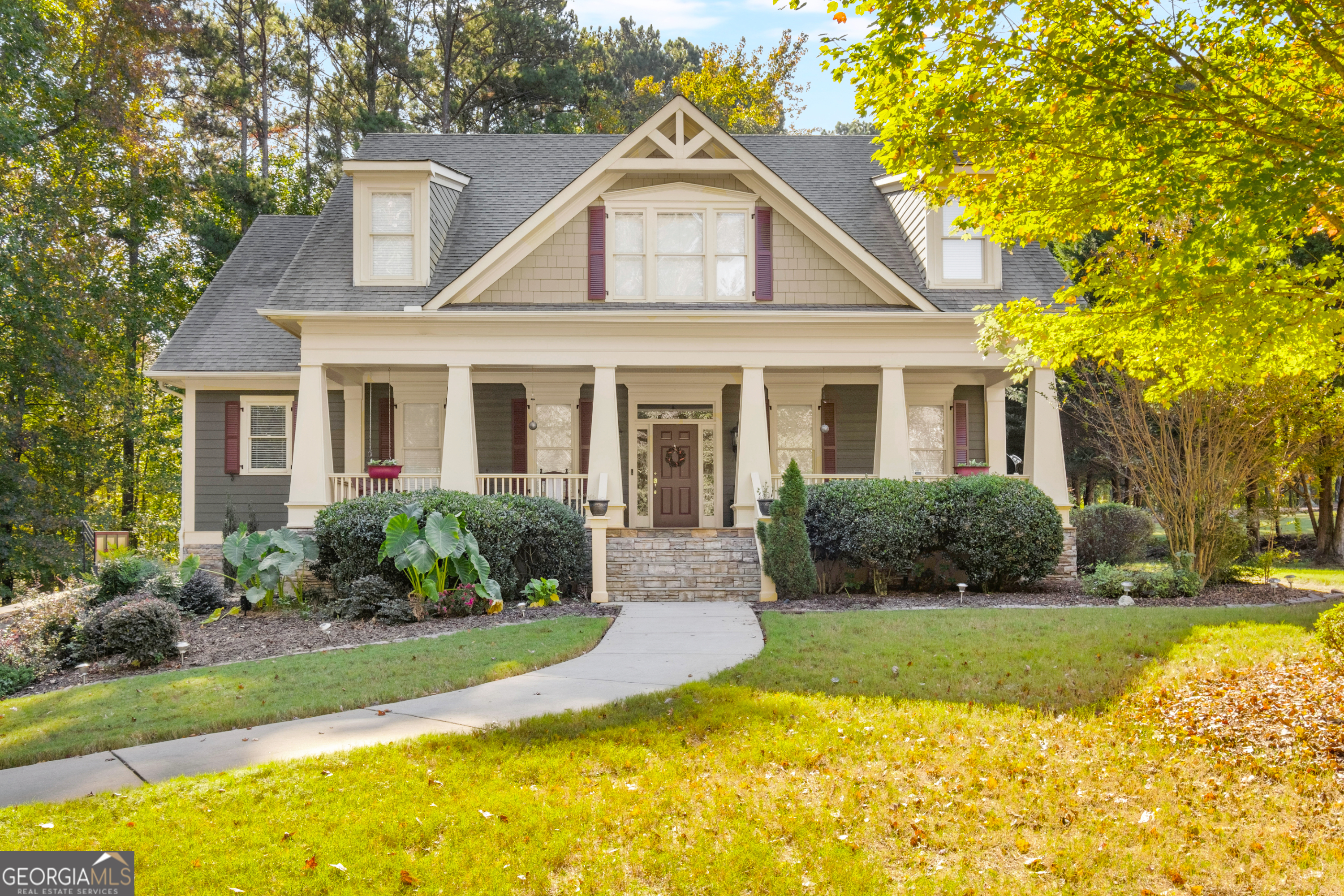 a front view of a house with yard and green space