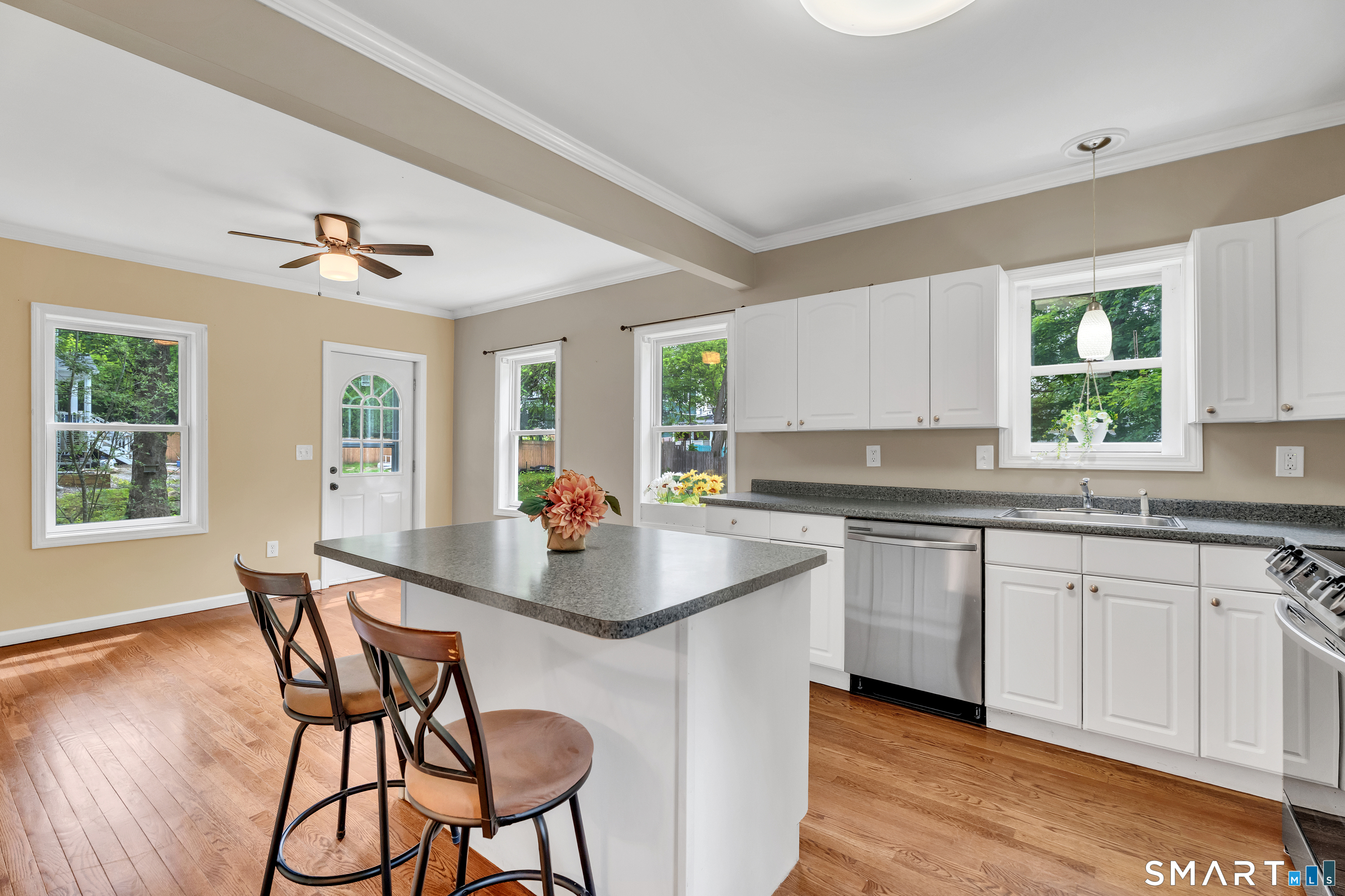75 Summit Street Norwich, CT 06360 - Photo 19 of 40 a kitchen with stainless steel appliances granite countertop a stove a sink a table and chairs