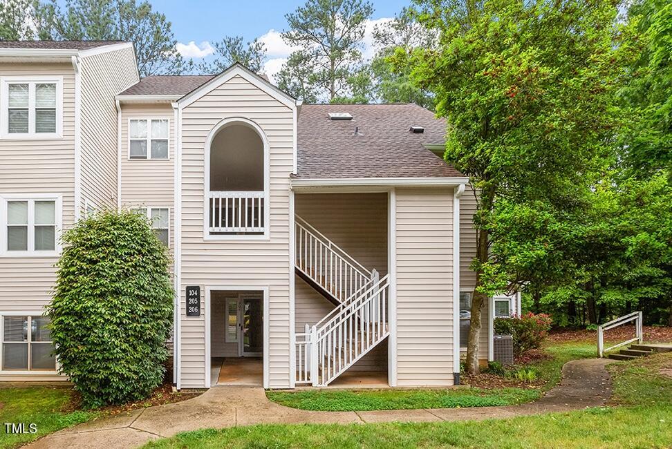 6011 Winterpointe Lane, Unit 104 Raleigh, NC 27606 - Photo 1 of 31 a view of a house with a yard