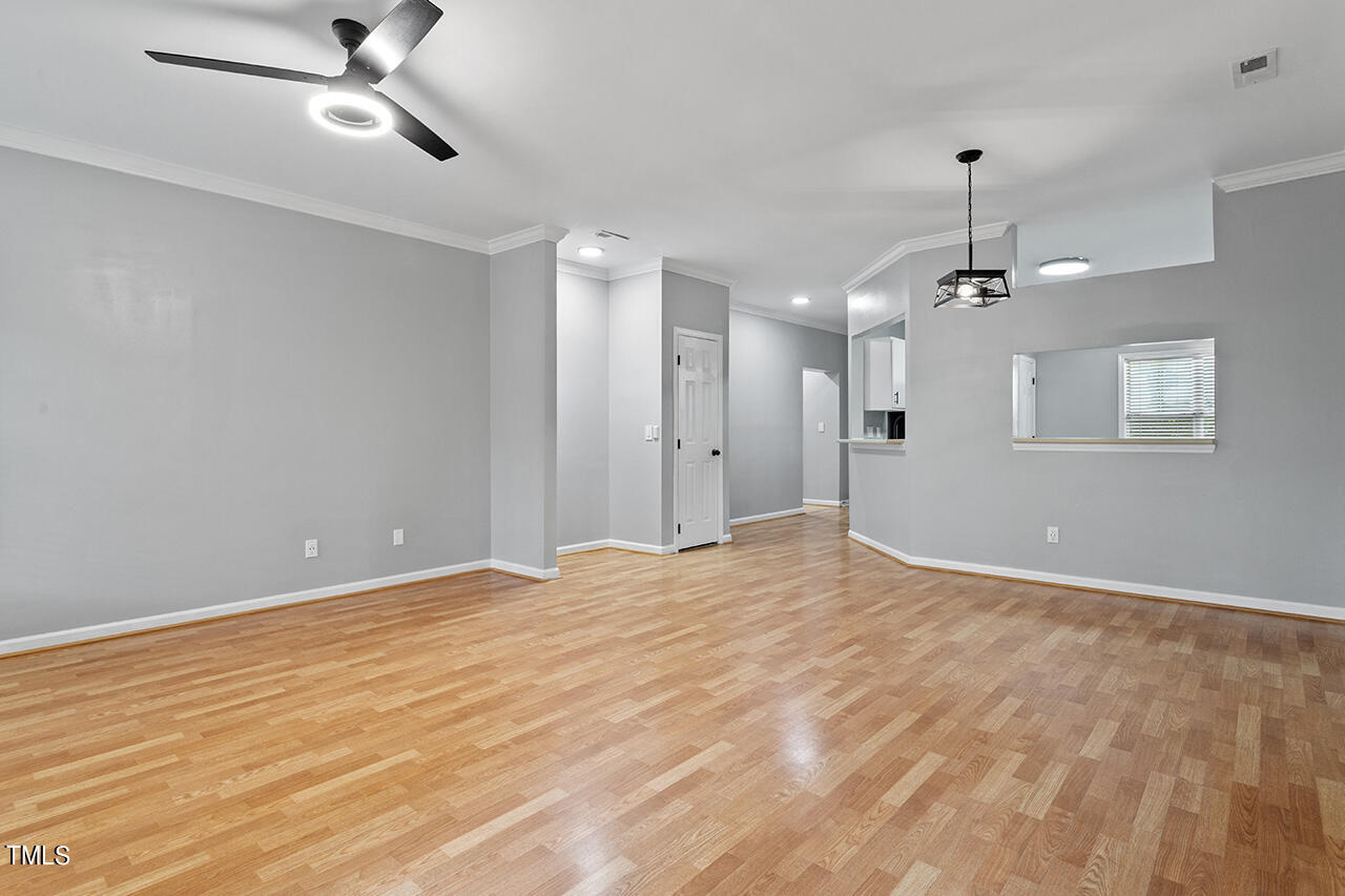 6011 Winterpointe Lane, Unit 104 Raleigh, NC 27606 - Photo 14 of 31 a view of an empty room with a chandelier fan