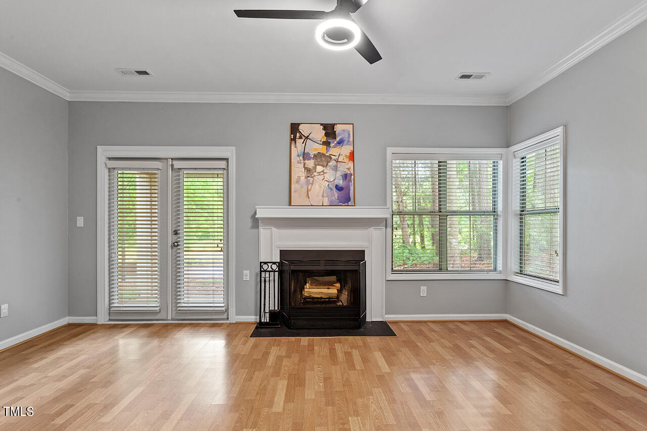 6011 Winterpointe Lane, Unit 104 Raleigh, NC 27606 - Photo 15 of 31 an empty room with windows and fireplace