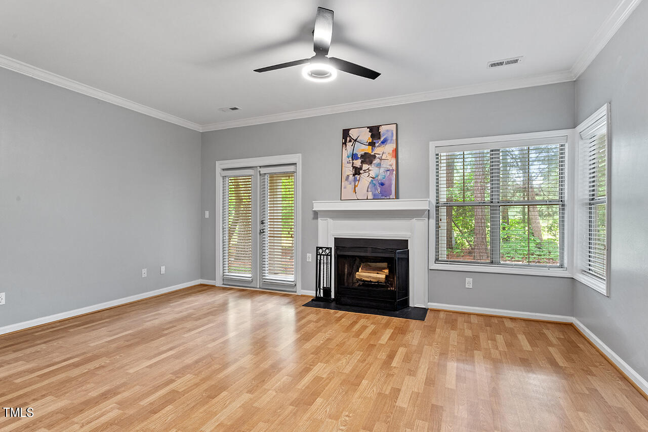 6011 Winterpointe Lane, Unit 104 Raleigh, NC 27606 - Photo 16 of 31 a view of empty room with a fireplace and window