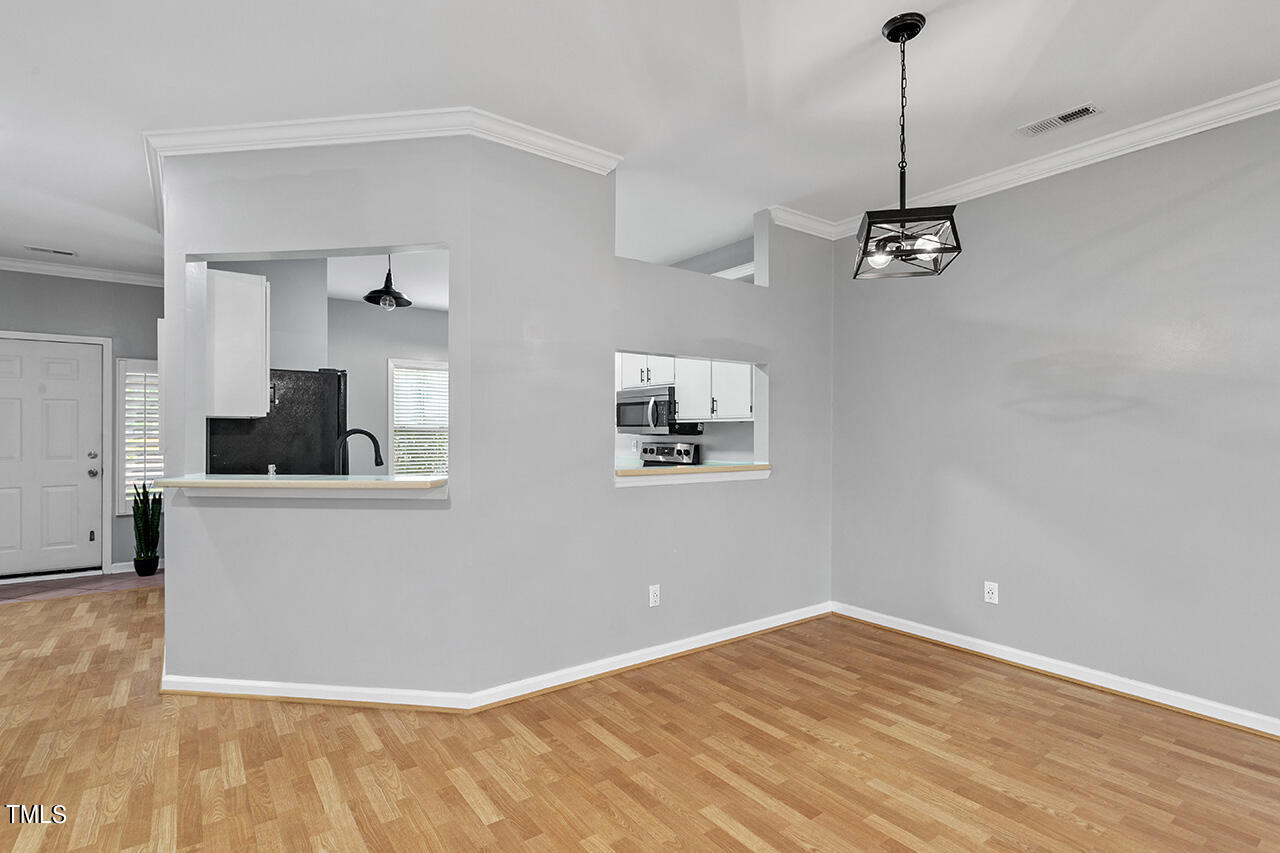 6011 Winterpointe Lane, Unit 104 Raleigh, NC 27606 - Photo 17 of 31 a view of empty room with wooden floor