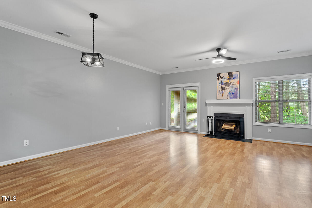 6011 Winterpointe Lane, Unit 104 Raleigh, NC 27606 - Photo 18 of 31 a view of empty room with fireplace and fan