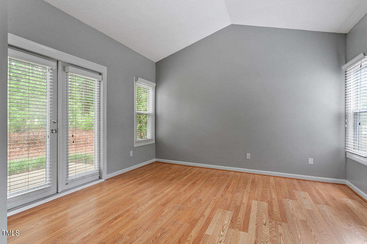 6011 Winterpointe Lane, Unit 104 Raleigh, NC 27606 - Photo 19 of 31 a view of an empty room with wooden floor and a window