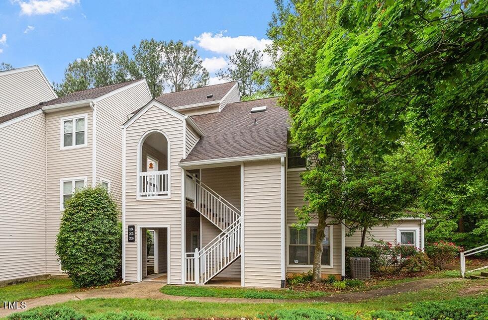 6011 Winterpointe Lane, Unit 104 Raleigh, NC 27606 - Photo 2 of 31 a front view of a house with a garden and plants