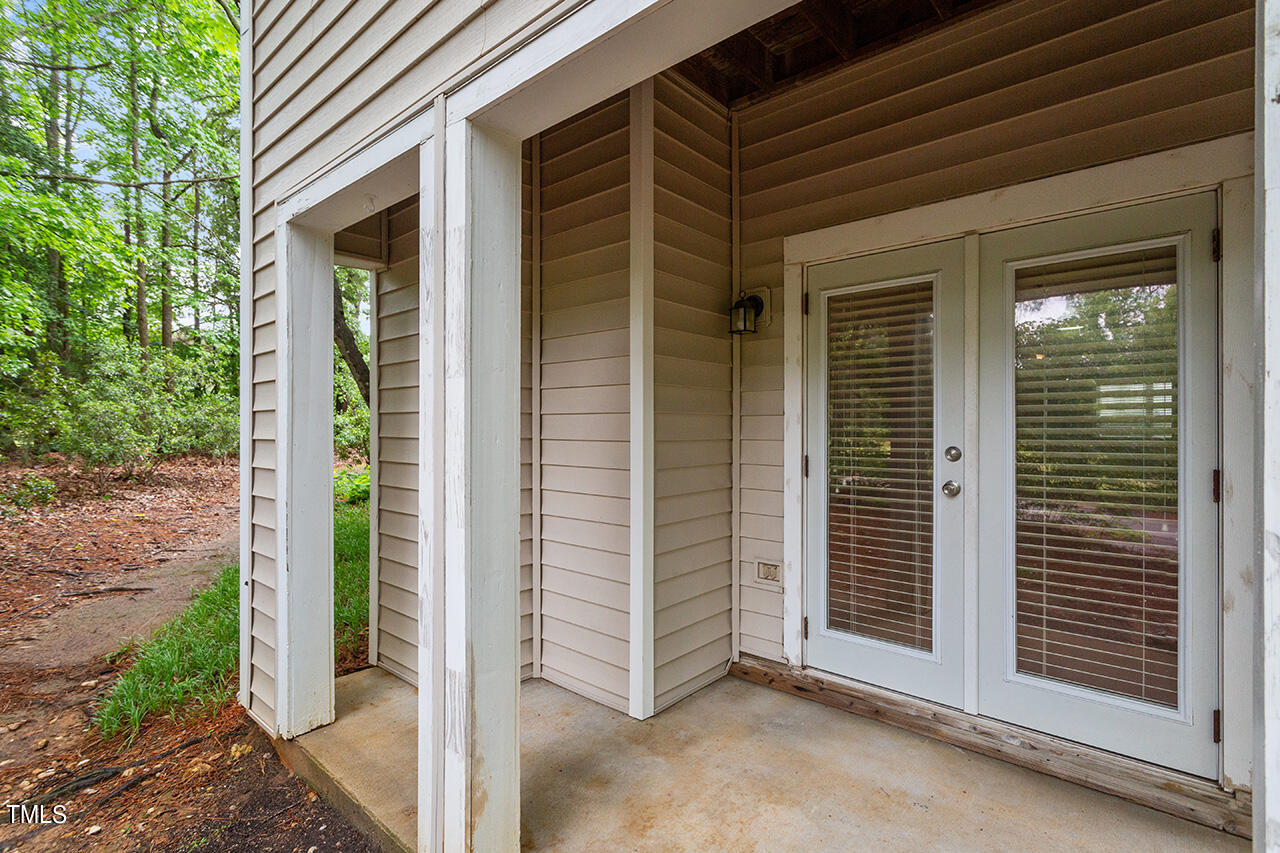 6011 Winterpointe Lane, Unit 104 Raleigh, NC 27606 - Photo 29 of 31 a view of a porch with a door and wooden floor