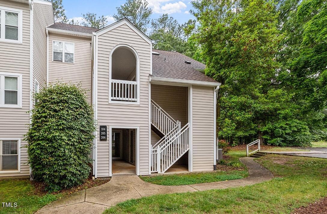 6011 Winterpointe Lane, Unit 104 Raleigh, NC 27606 - Photo 3 of 31 a front view of a house with a yard