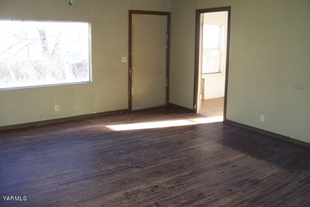 10840 Hughes Road Yakima, WA 98903 - Photo 5 of 8 an empty room with wooden floor and windows