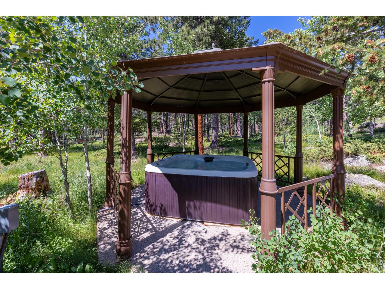 187 Lynx Drive Ward, CO 80481 - Photo 38 of 50 a view of a patio with table and chairs under an umbrella