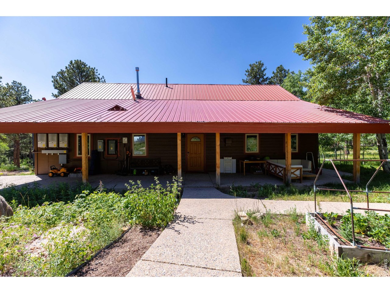187 Lynx Drive Ward, CO 80481 - Photo 40 of 50 a front view of a house with garden