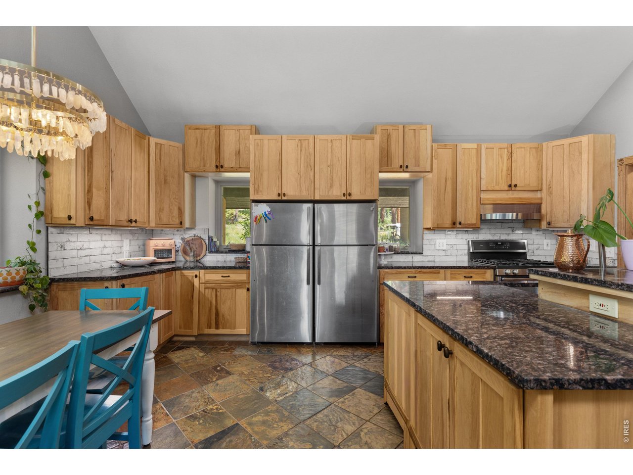 187 Lynx Drive Ward, CO 80481 - Photo 6 of 50 a kitchen with refrigerator and cabinets
