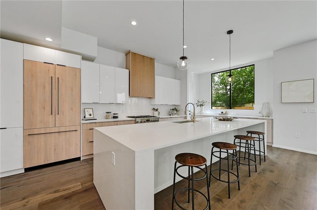 1904 Collier Street Austin, TX 78704 - Photo 12 of 31 a kitchen with a sink a center island stainless steel appliances and cabinets