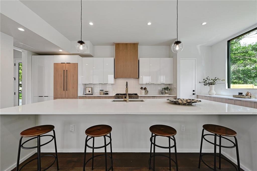1904 Collier Street Austin, TX 78704 - Photo 13 of 31 a kitchen with stainless steel appliances a table chairs sink and cabinets