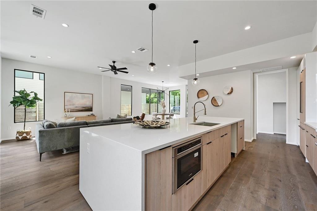 1904 Collier Street Austin, TX 78704 - Photo 31 of 31 a kitchen with kitchen island a sink stove and wooden floor
