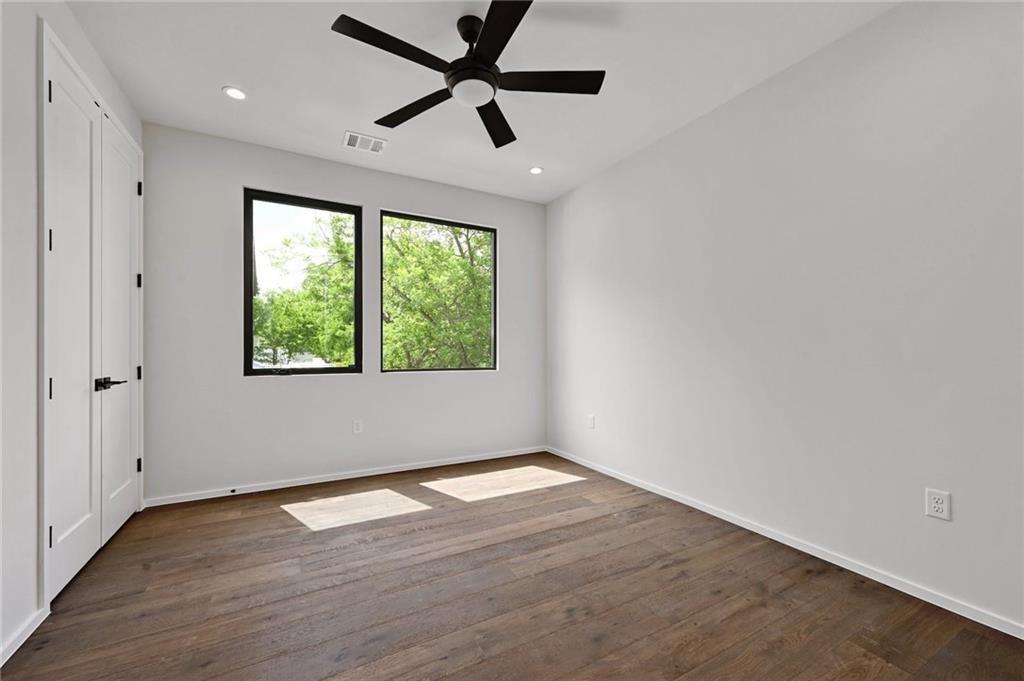 1904 Collier Street Austin, TX 78704 - Photo 17 of 31 an empty room with wooden floor fan and windows