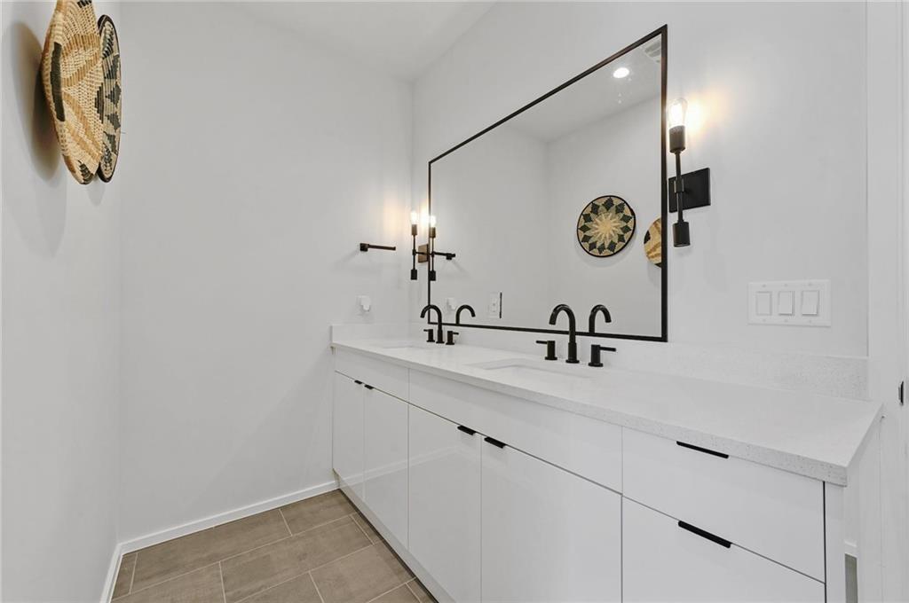 1904 Collier Street Austin, TX 78704 - Photo 19 of 31 a bathroom with a sink and a mirror
