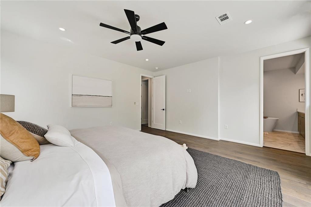 1904 Collier Street Austin, TX 78704 - Photo 21 of 31 a bedroom with a large bed chandelier and a window