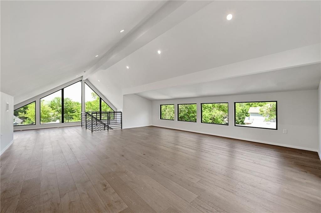 1904 Collier Street Austin, TX 78704 - Photo 26 of 31 an empty room with large windows and stairs