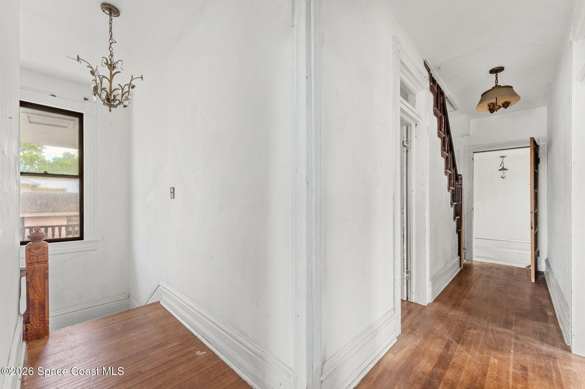 1101 Rockledge Drive Rockledge, FL 32955 - Photo 39 of 76 a view of a hallway with wooden floor and staircase