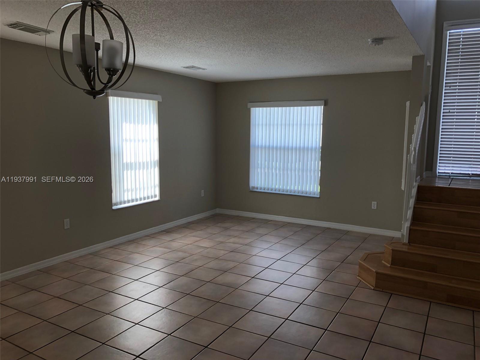 11274 Southwest 64th Lane Miami, FL 33173 - Photo 12 of 34 an empty room with windows