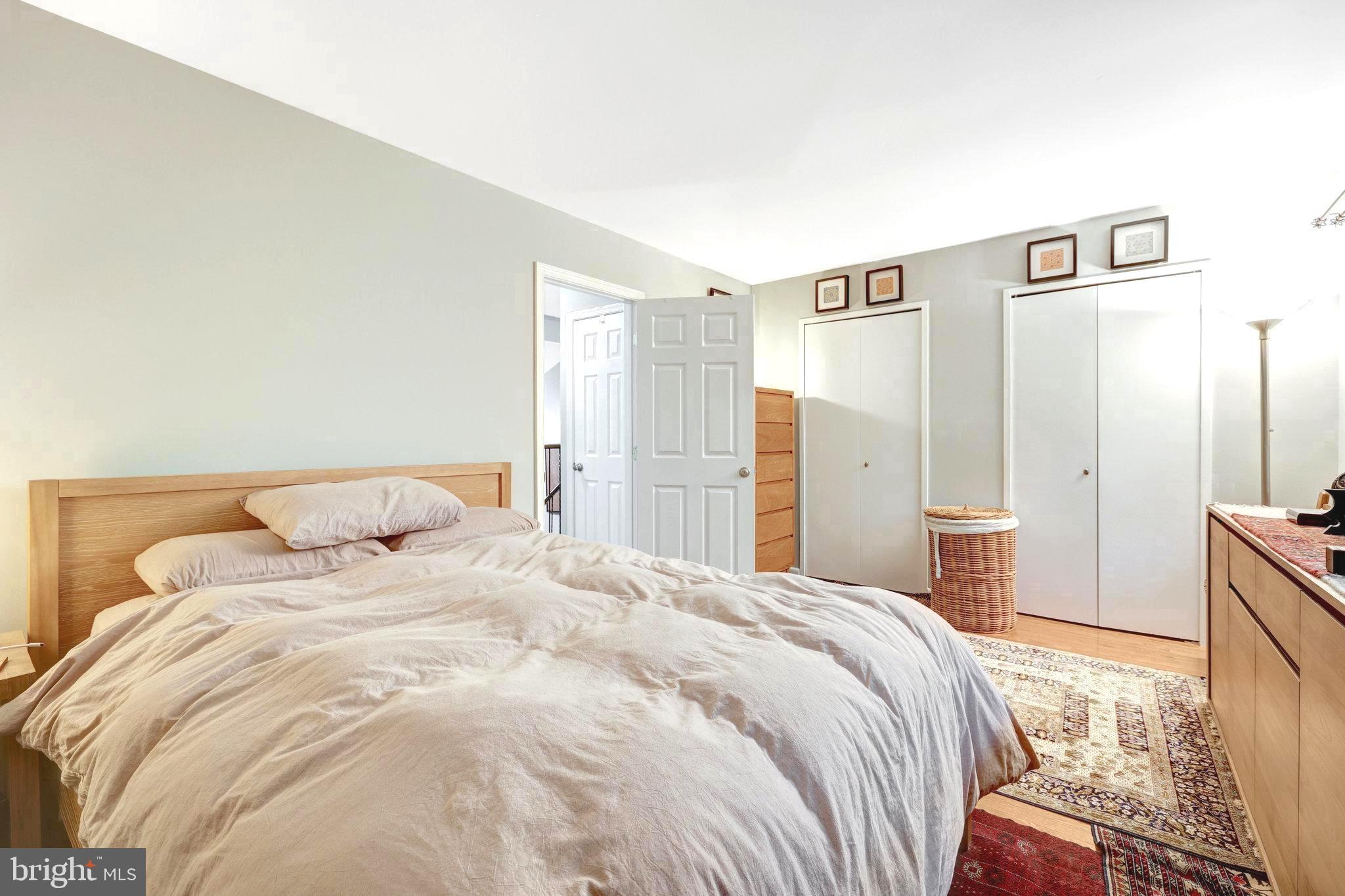 2045 Headlands Circle Reston, VA 20191 - Photo 6 of 32 a large bed sitting in a bedroom and a table