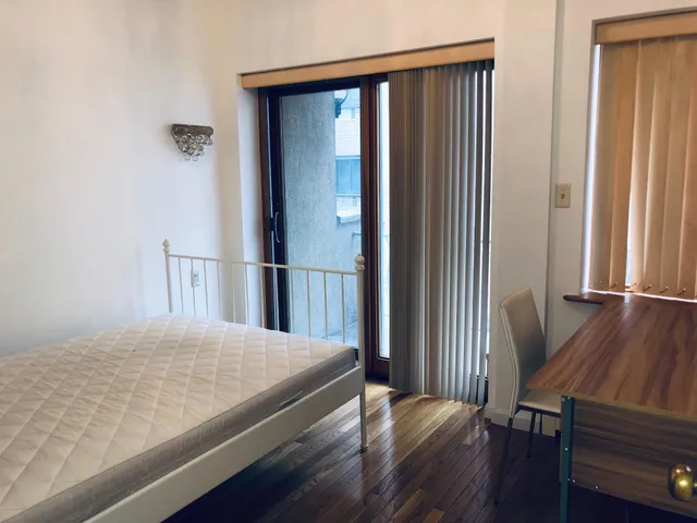 a view of bedroom with wooden floor