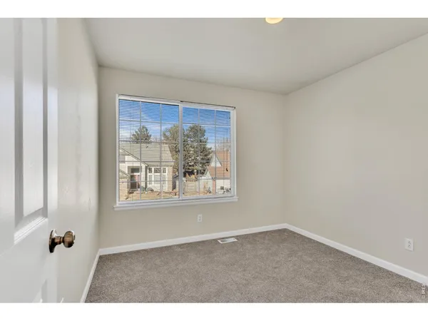 a big room with closet and wooden floor