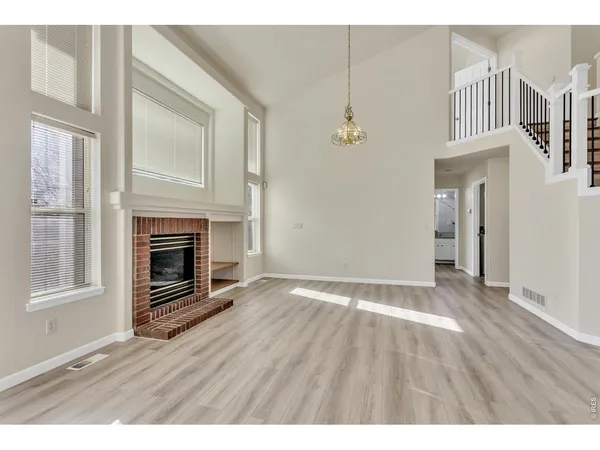 a kitchen with granite countertop a refrigerator stove top oven and cabinets