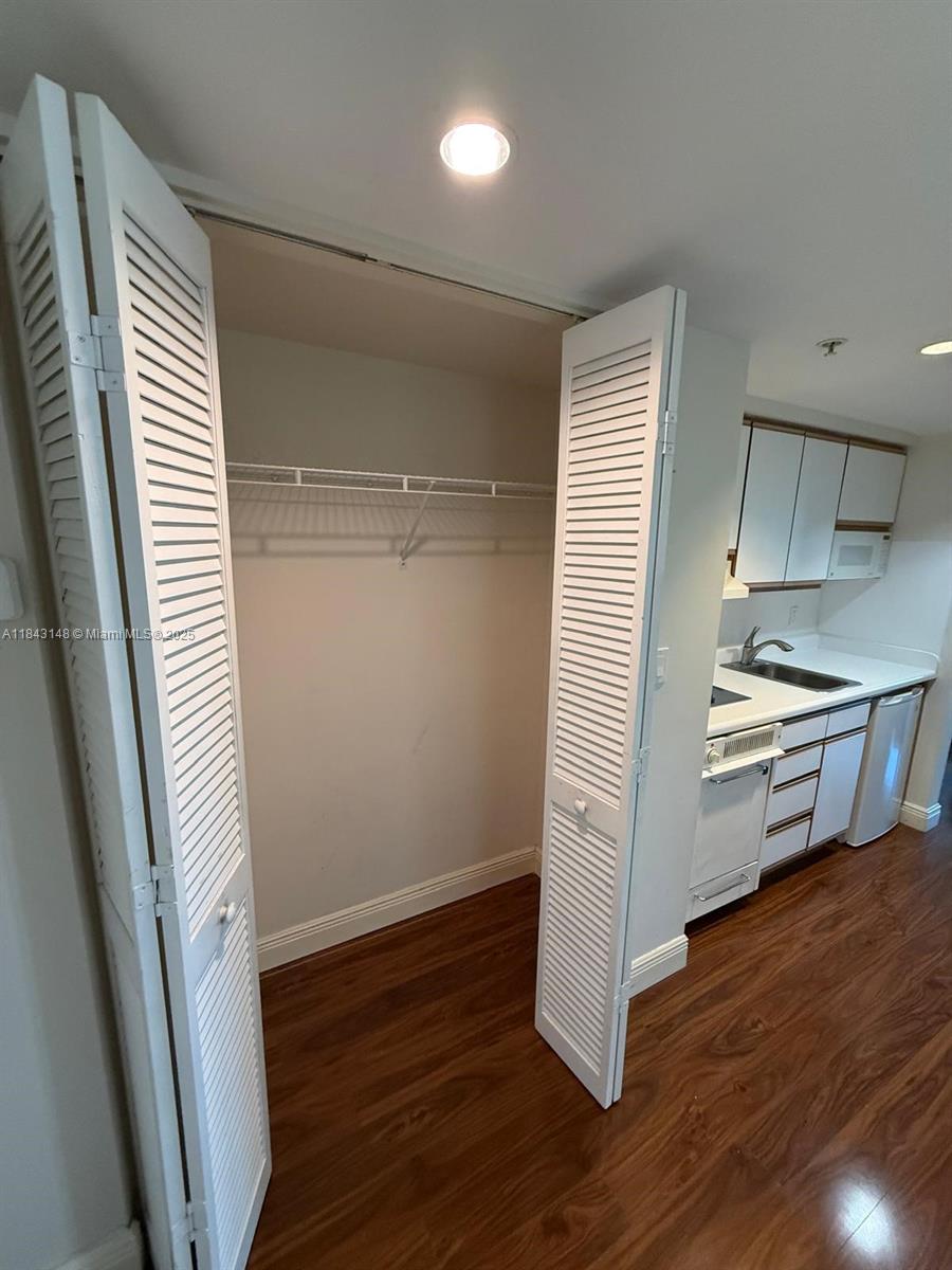 5715 Southwest 72nd Street, Unit 5715 South Miami, FL 33143 - Photo 5 of 6 a view of a kitchen with wooden floor and electronic appliances