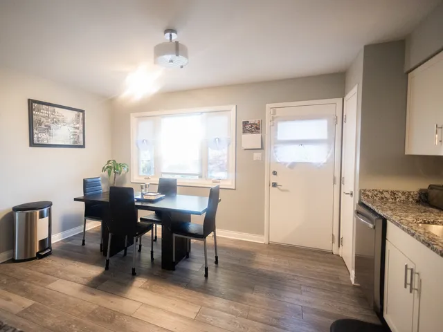 a view of a dining room with furniture and wooden floor