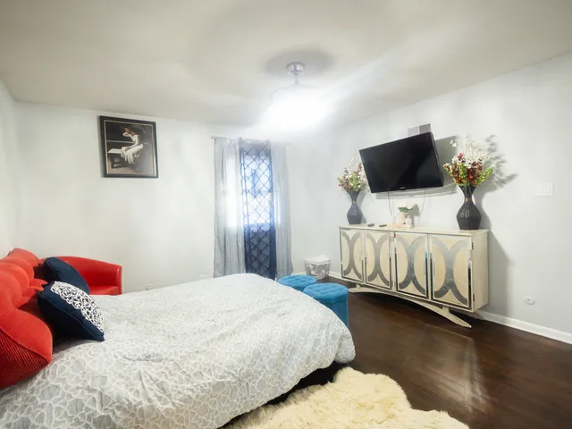 a bedroom with a bed and flat screen tv