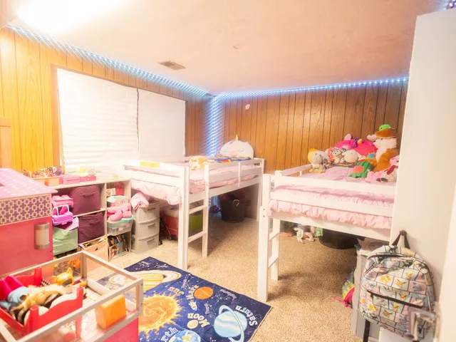 a bed room with a bed cabinets and a window