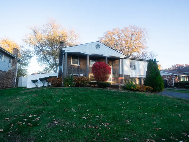 a front view of house with yard and green space