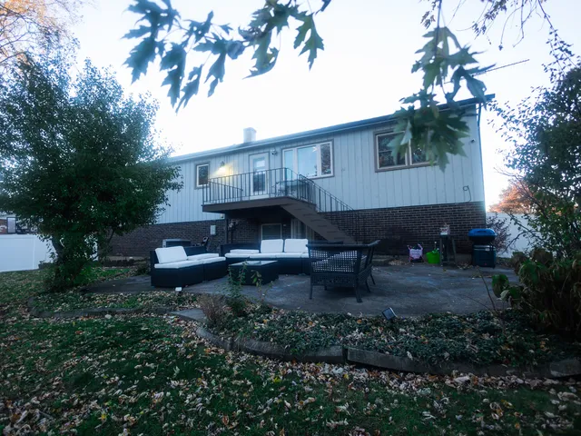 a view of a house with a yard and sitting area