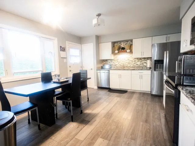 a kitchen with granite countertop a sink appliances and cabinets