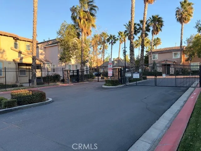 a view of a street with a cars parked in front of it