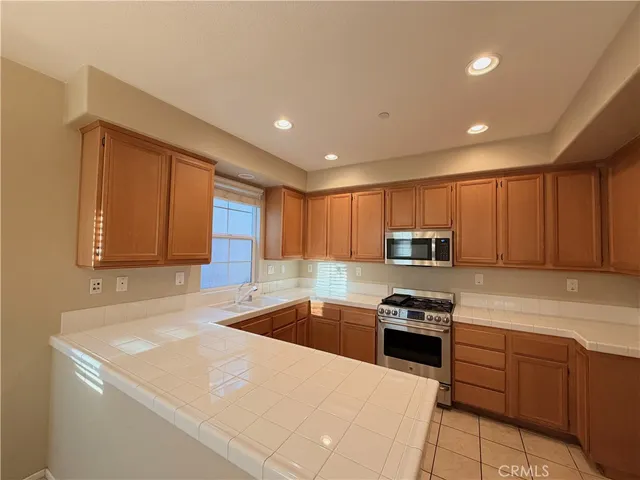 a kitchen with a sink a stove and cabinets