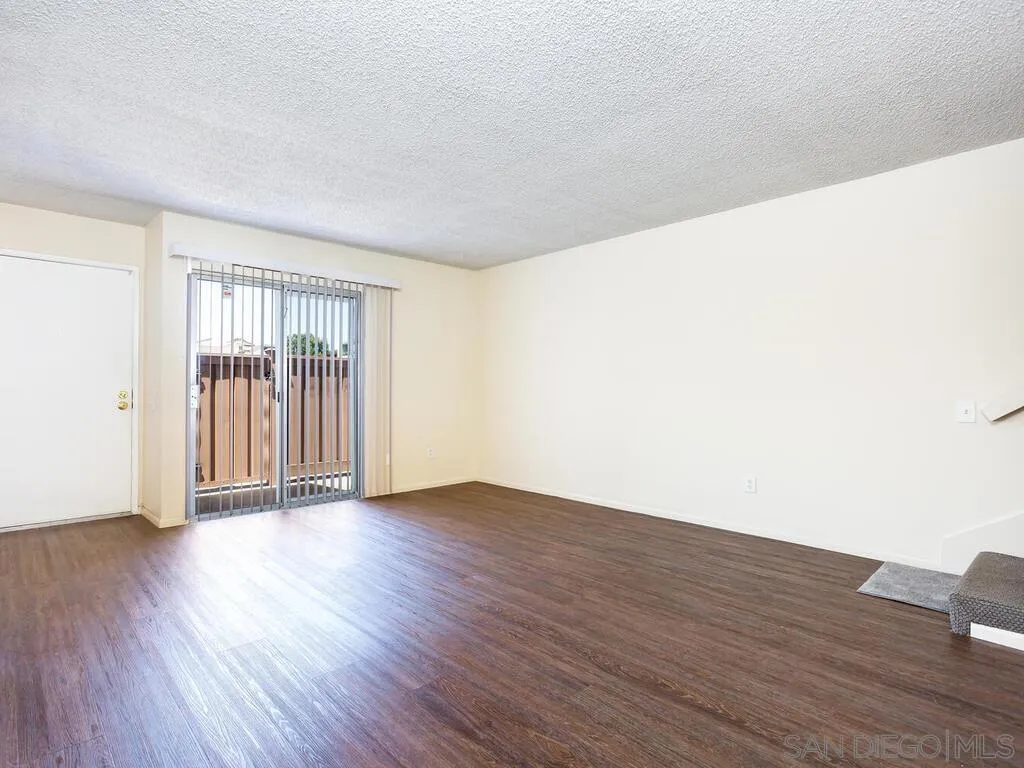 3550 Ruffin Road, Unit 185 San Diego, CA 92123 - Photo 3 of 13 a view of an empty room with wooden floor