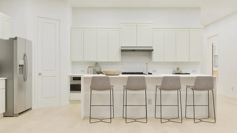 107 Brabham Loop Hutto, TX 78634 - Photo 11 of 21 a white kitchen with cabinets and chairs